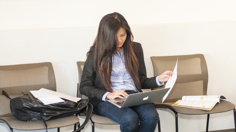 person at the UC Berkeley career center, sitting down and preparing documents