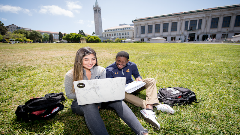 students on computer in front of doe library